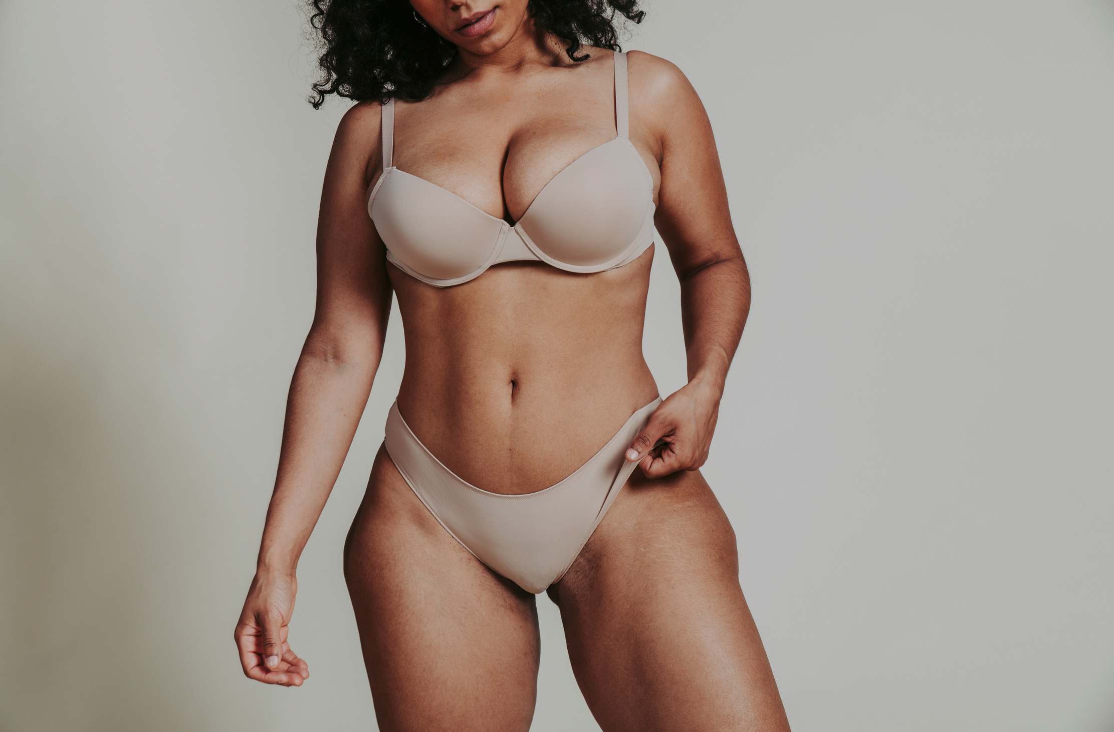 Body Acceptance Concept.  Curvy Girl Posing in Studio against so